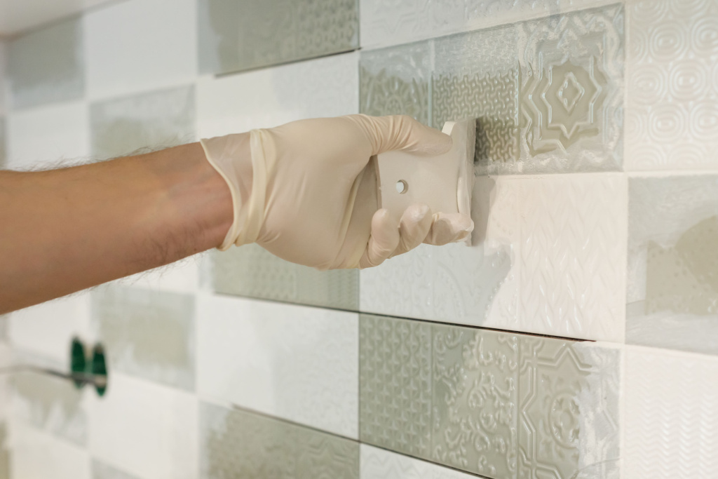 closeup-tiler-hand-rubbing-tile-installing-grouting-decorative-finishes.jpg closeup-tiler-hand-rubbing-tile-installing-grouting-decorative-finishes.jpg
